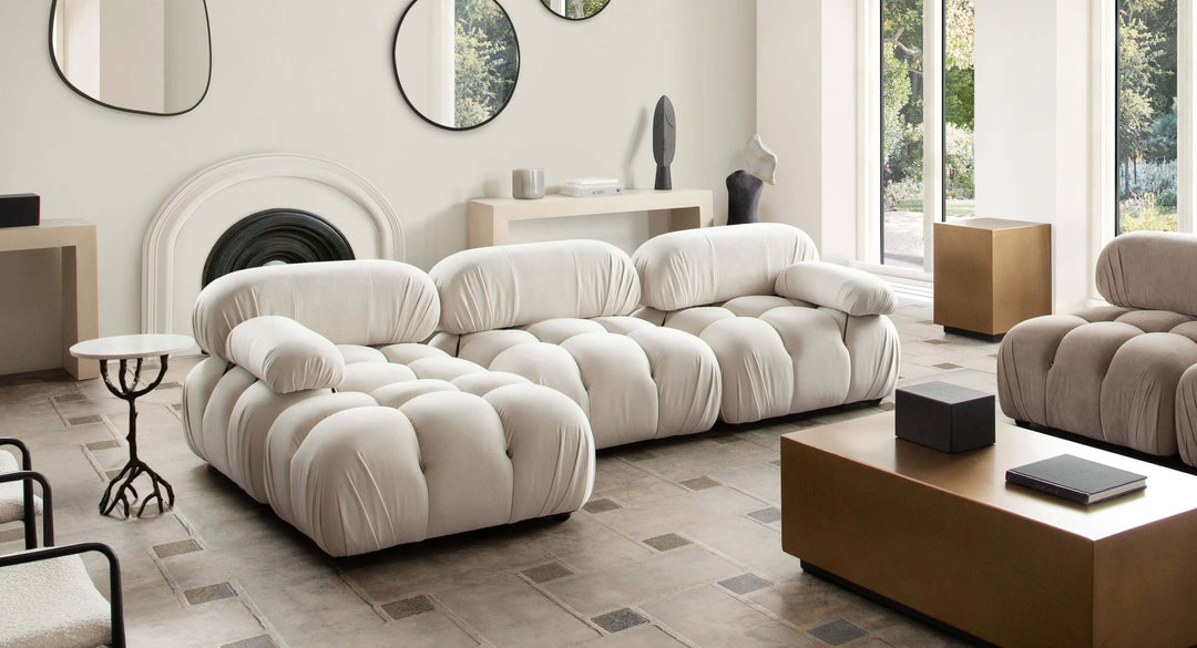 Cream Modular Left Facing Chaise Sectional In Large Living Room With Mirrors on back wall 